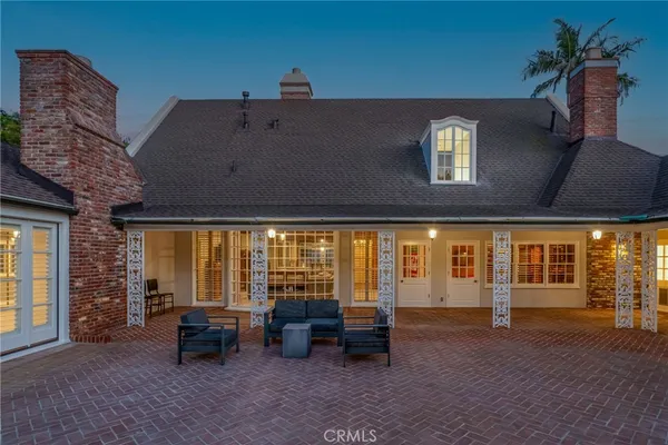 a view of a house with a backyard porch and sitting area