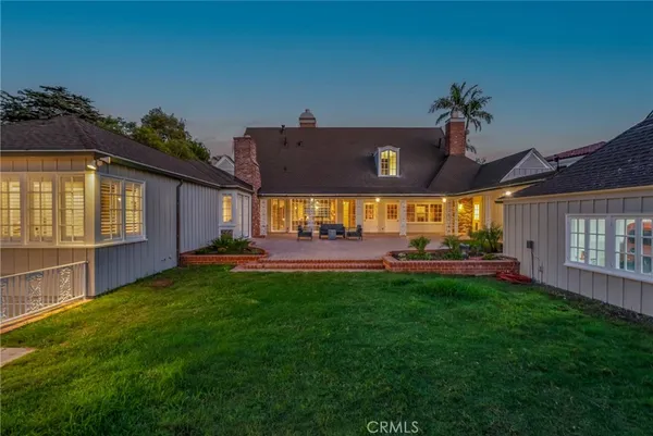 a view of a house with backyard and sitting area