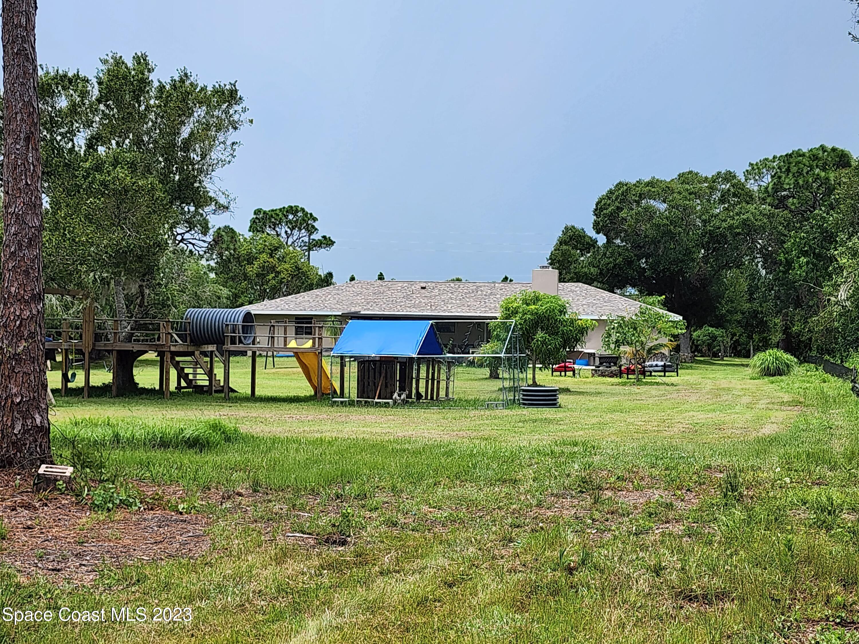 2745 Corey Road Malabar, FL 32950 - Photo 37 of 39 a front view of a house with garden