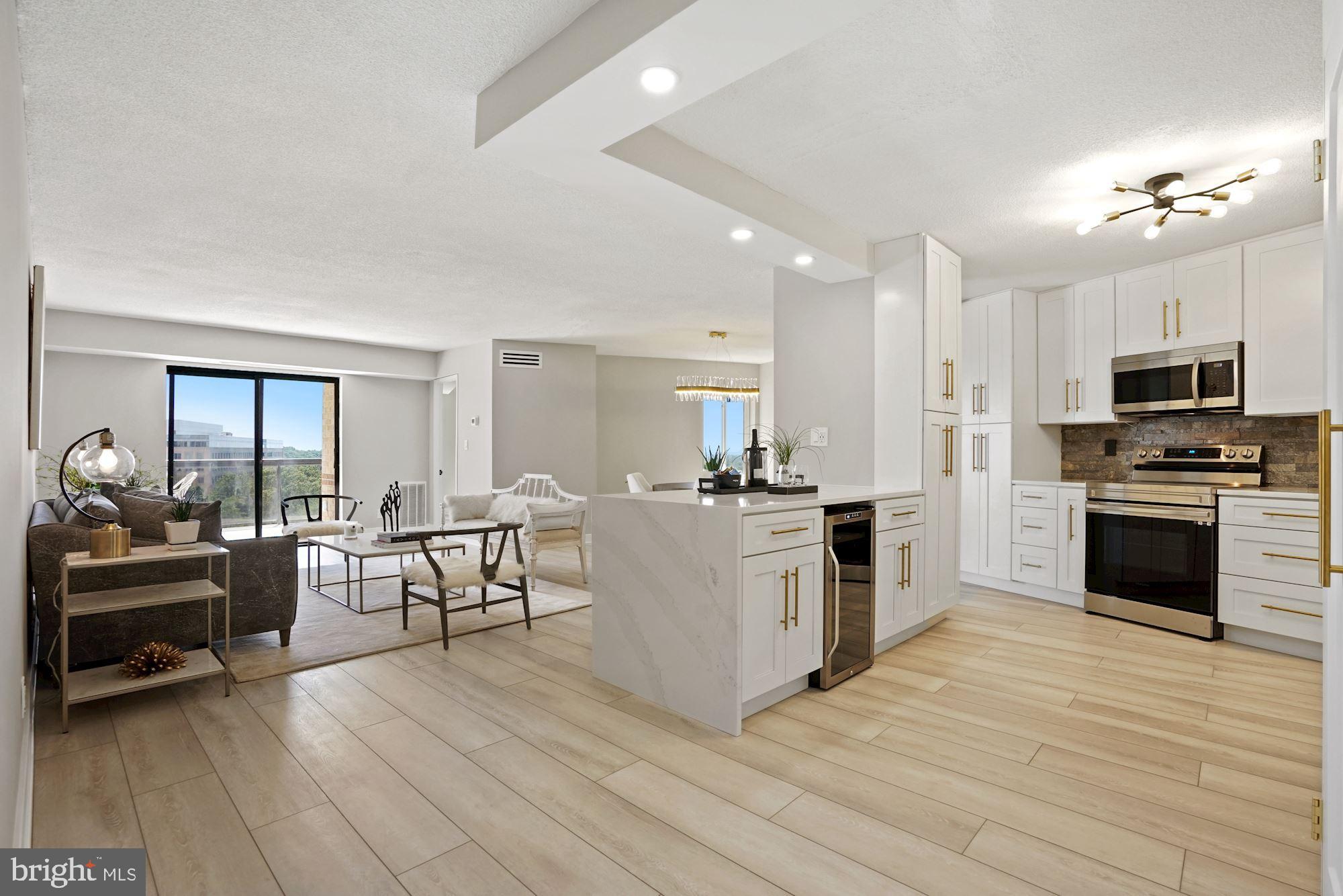 a kitchen with a sink cabinets and wooden floor