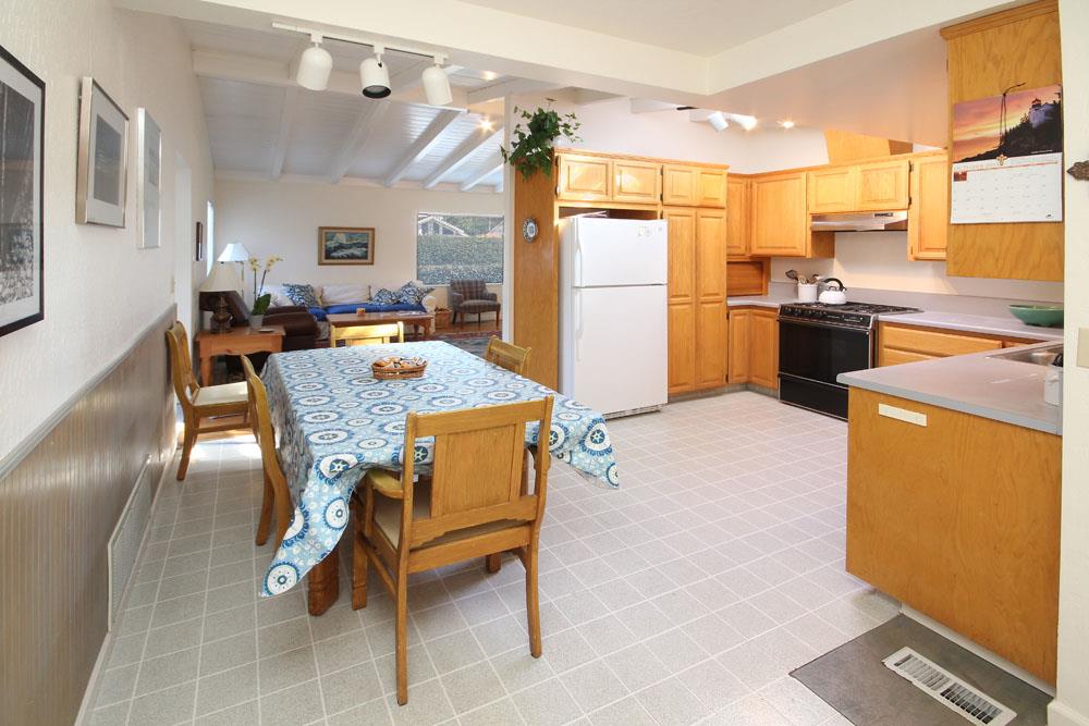 611 Middlefield Drive Aptos, CA 95003 - Photo 4 of 11 a kitchen with a table chairs refrigerator and cabinets