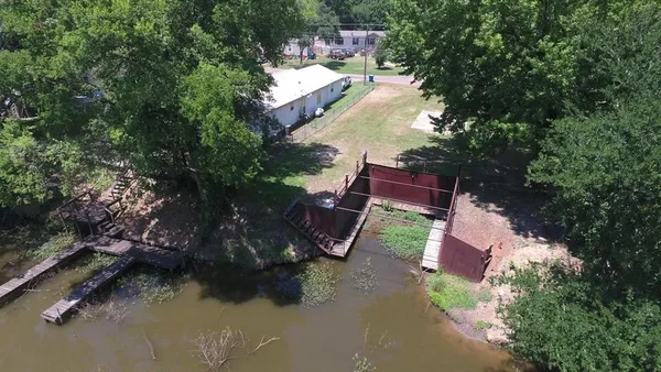 an aerial view of a house with outdoor space pool seating area and yard