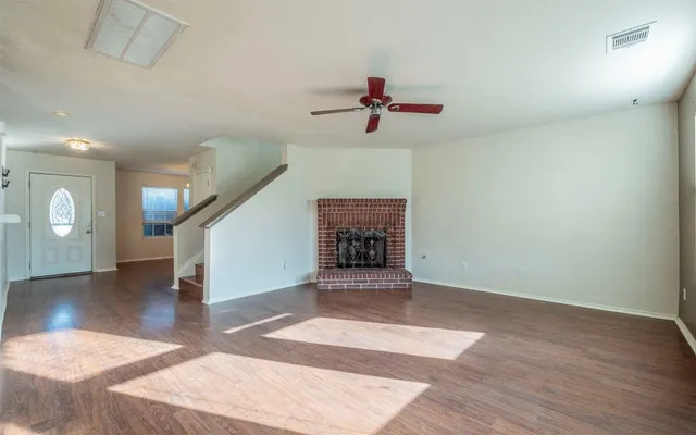 wooden floor in an empty room with a window