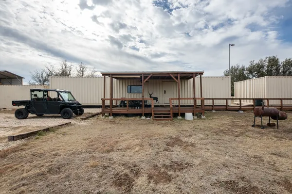 a view of a house with backyard and sitting area