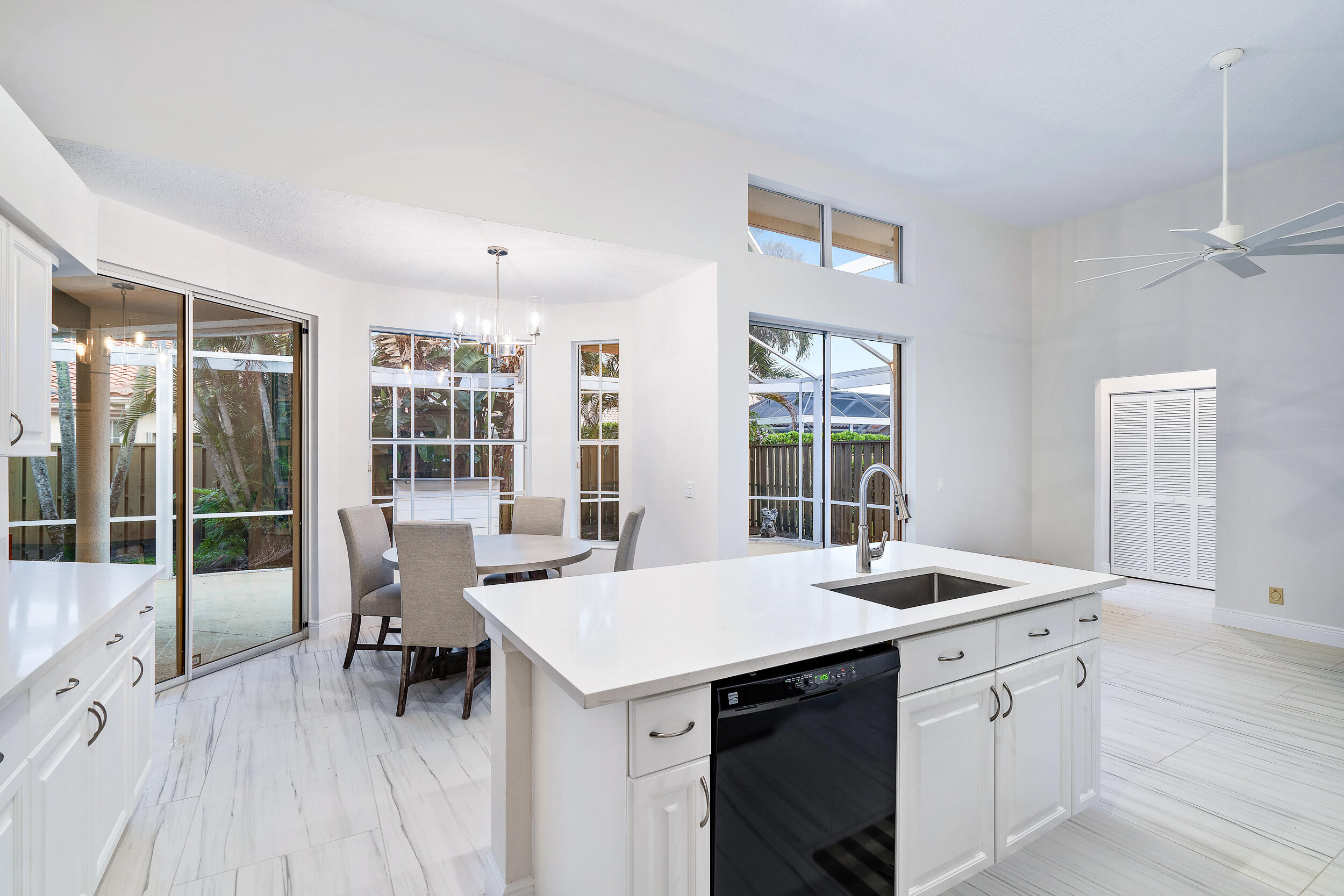 207 Eagleton Estates Boulevard Palm Beach Gardens, FL 33418 - Photo 17 of 33 a kitchen that has a sink and a table in it