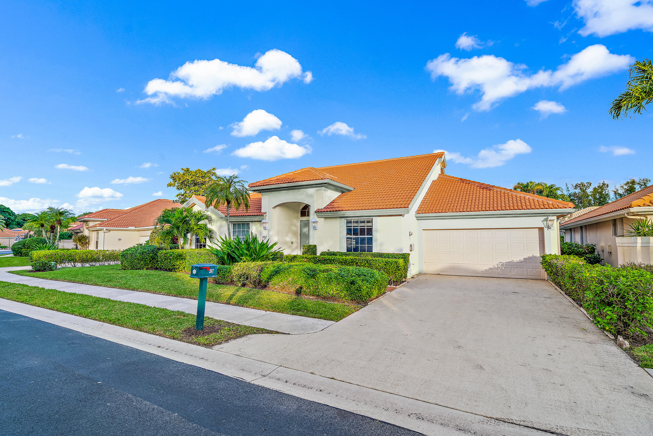 207 Eagleton Estates Boulevard Palm Beach Gardens, FL 33418 - Photo 2 of 33 a front view of a house with a yard and garage