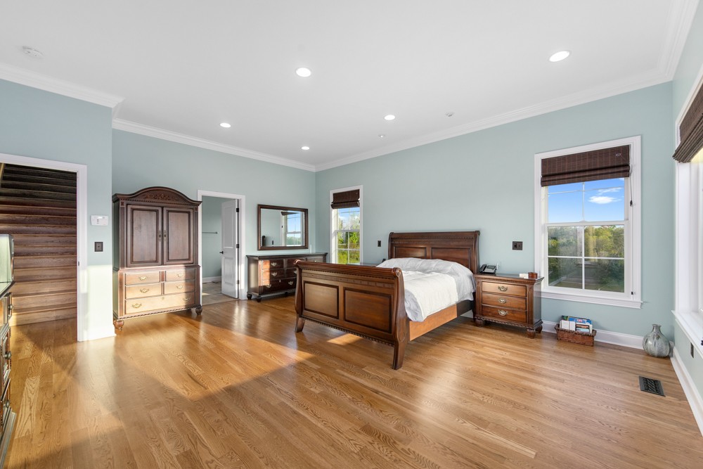 1895 French Brantley Road Wartrace, TN 37183 - Photo 32 of 50 a spacious bedroom with a large bed and a wooden floor
