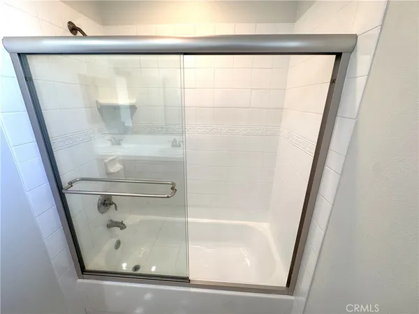 a bathroom with a glass shower door