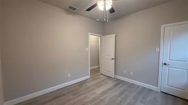 an empty room with a empty space and a ceiling fan
