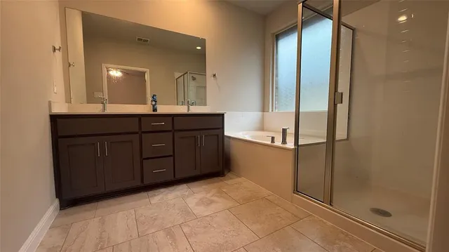 a bathroom with a double vanity sink and mirror