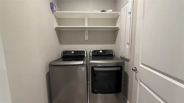 a view of storage and utility room with washer and dryer