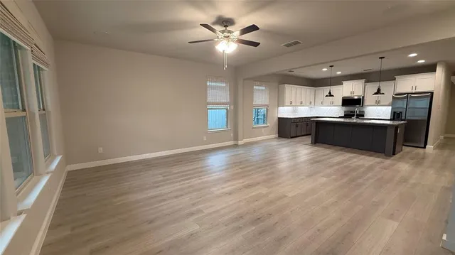 a view of kitchen with refrigerator and window