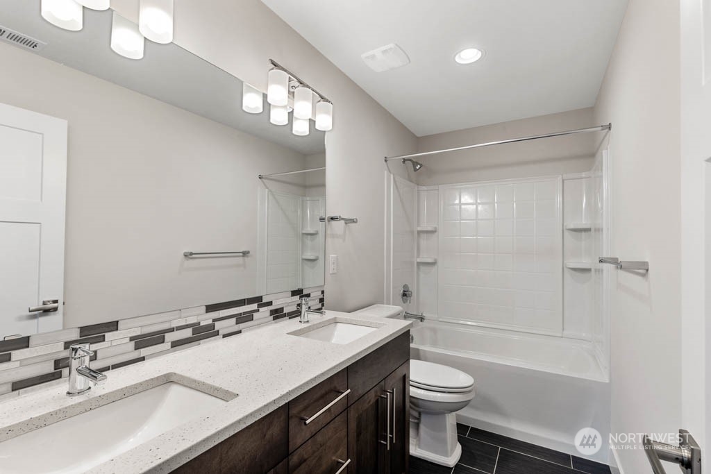 22921 20th Place West Bothell, WA 98021 - Photo 24 of 27 a bathroom with a sink a toilet a mirror and shower