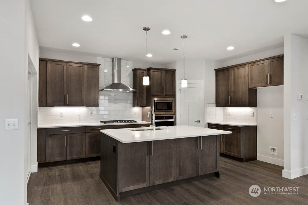 22921 20th Place West Bothell, WA 98021 - Photo 5 of 27 a large kitchen with stainless steel appliances kitchen island a cabinets and a counter space