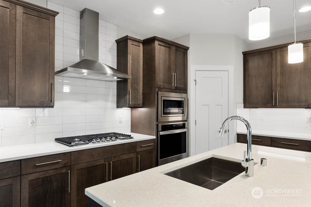 22921 20th Place West Bothell, WA 98021 - Photo 6 of 27 a kitchen with a sink a stove and refrigerator