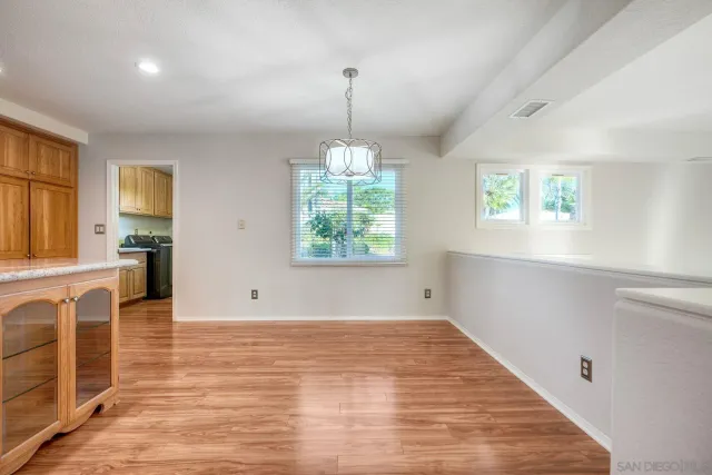 a view of a storage and utility room with sink dryer and washer