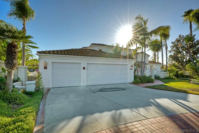 a view of a house with a yard and palm trees