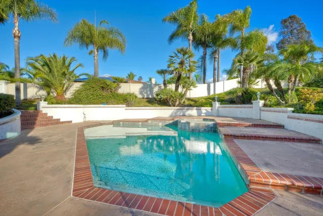 a view of a house with a backyard porch and sitting area