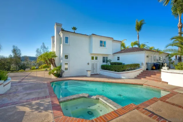 a view of a yard with plants and large trees