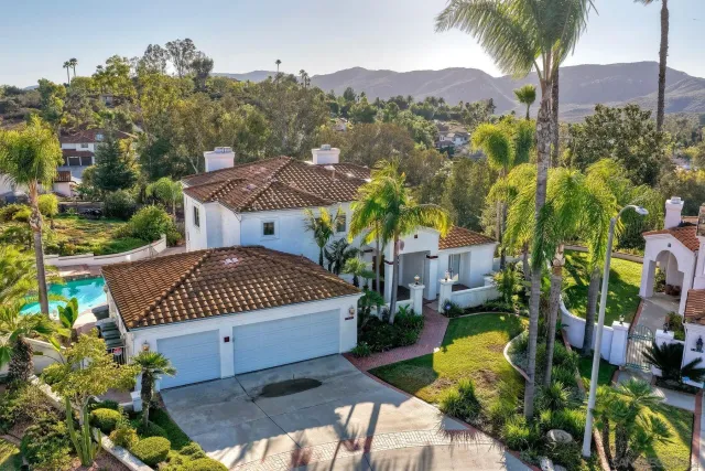 an aerial view of residential houses with outdoor space and street view