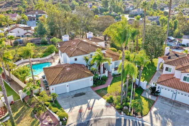 an aerial view of a house with a yard and garden