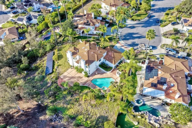 an aerial view of a house with a yard and garden