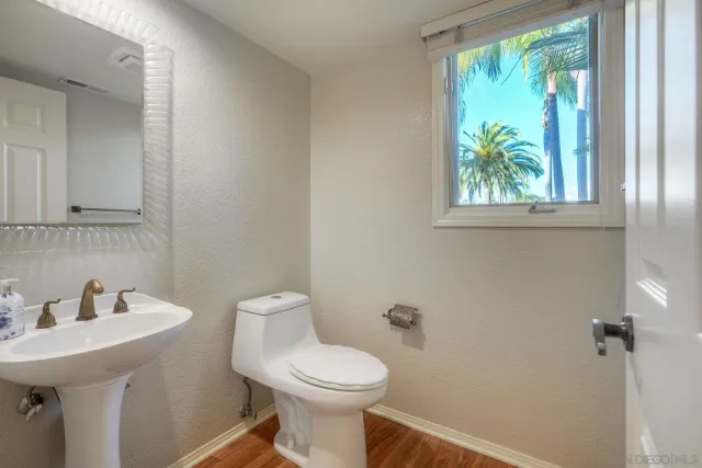 a large kitchen with stainless steel appliances granite countertop a stove a sink and a wooden floors