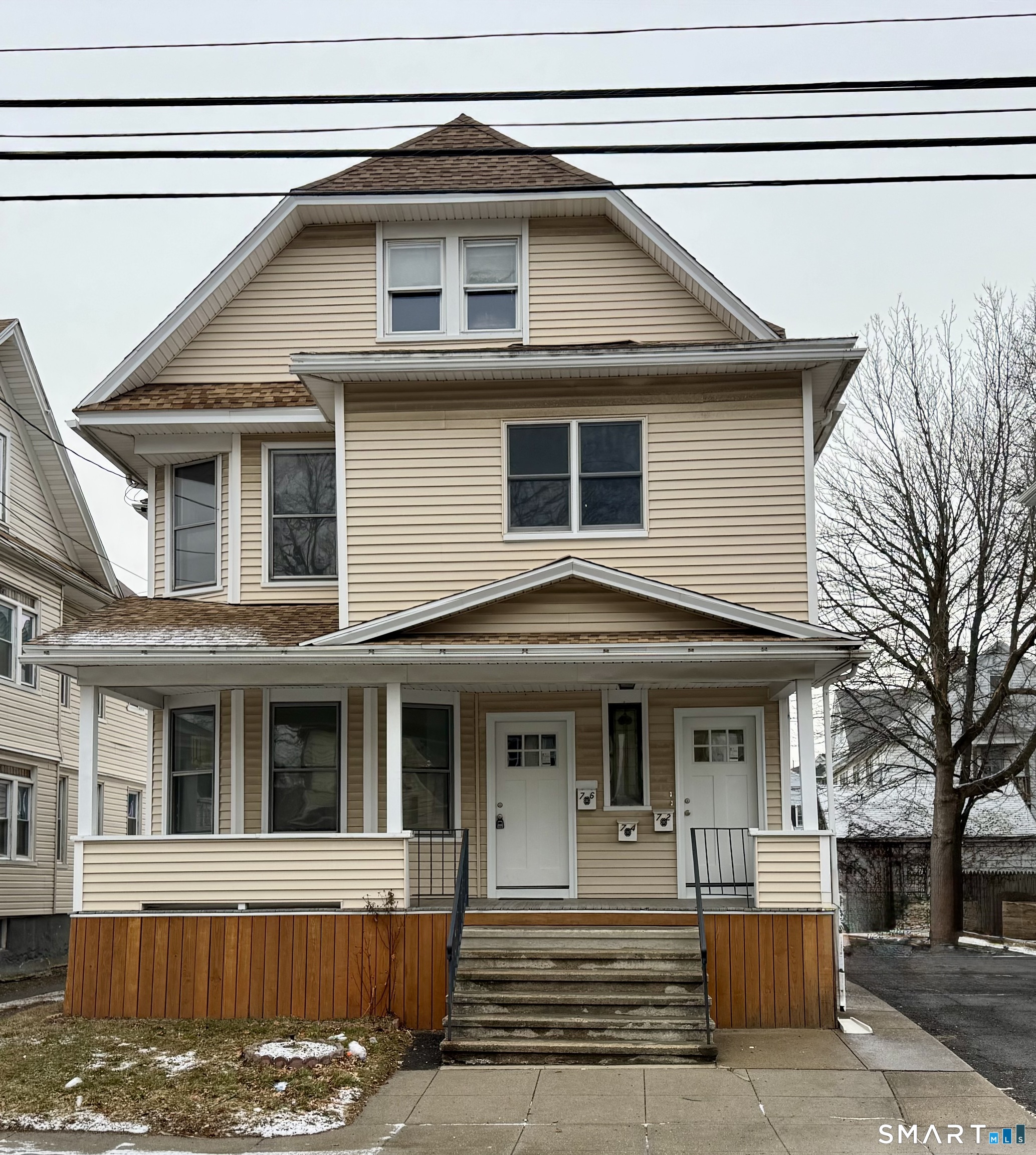 74 Garfield Avenue Bridgeport, CT 06606 - Photo 1 of 14 a front view of a house with a yard