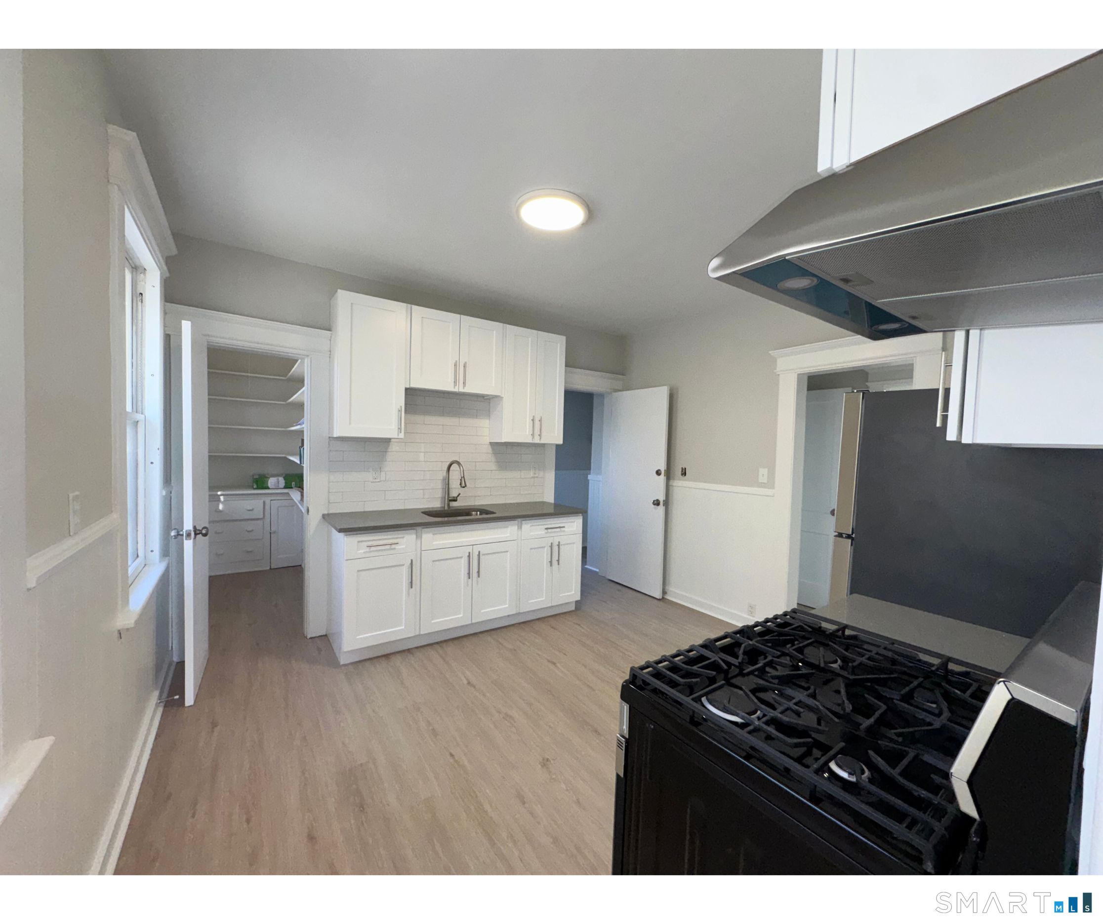 74 Garfield Avenue Bridgeport, CT 06606 - Photo 13 of 14 a kitchen with stainless steel appliances granite countertop a stove a sink and a refrigerator