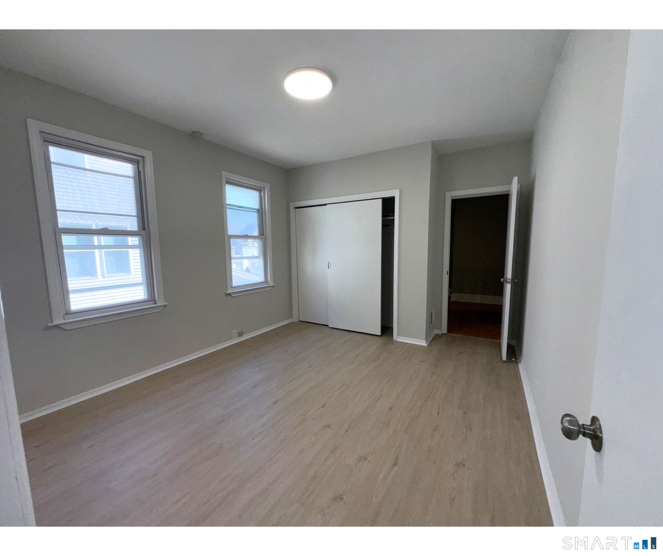74 Garfield Avenue Bridgeport, CT 06606 - Photo 7 of 14 a view of an empty room with closet and a window