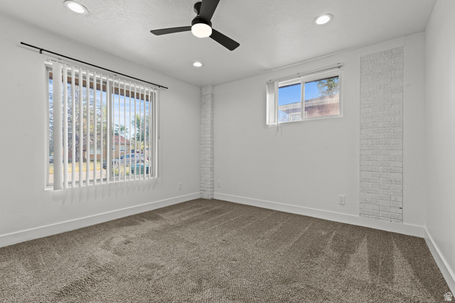 2101 West 3900th Street South Roy, UT 84067 - Photo 12 of 36 Carpeted interior space featuring white walls and a contemporary black ceiling fan with integrated lighting