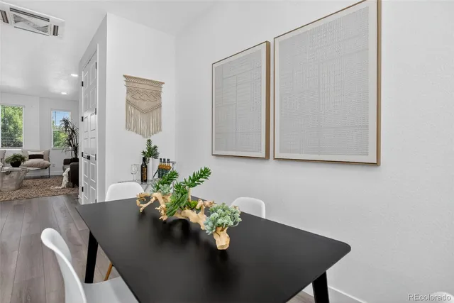 a kitchen with stainless steel appliances granite countertop a dining table chairs a microwave a sink and a stove