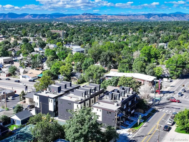 a view of a patio with furniture and a garden