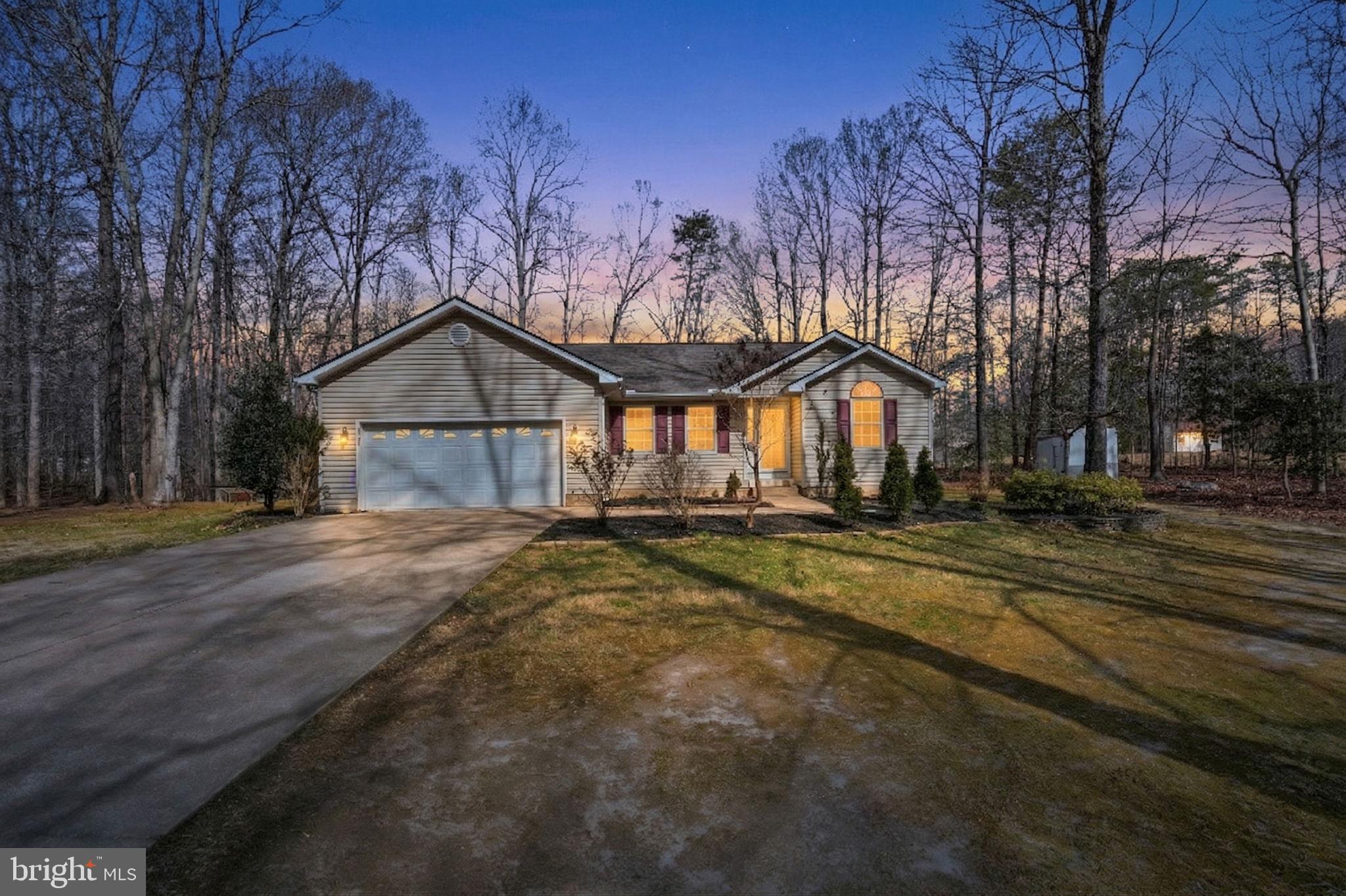 a view of a house with a yard and tree s