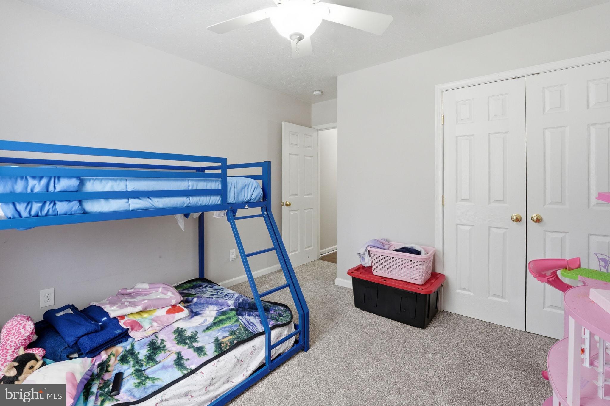 9334 Inaugural Drive King George, VA 22485 - Photo 14 of 26 a bedroom with a bed and a chandelier