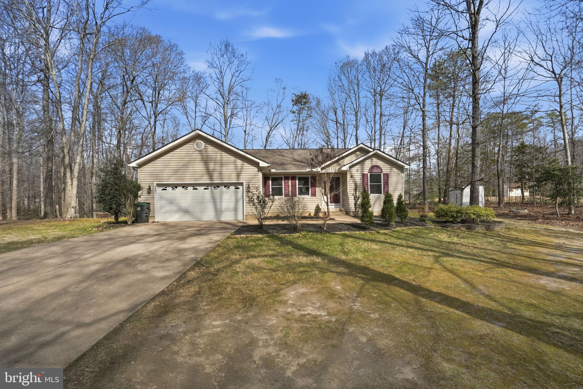 9334 Inaugural Drive King George, VA 22485 - Photo 2 of 26 a view of a house with a yard and garage