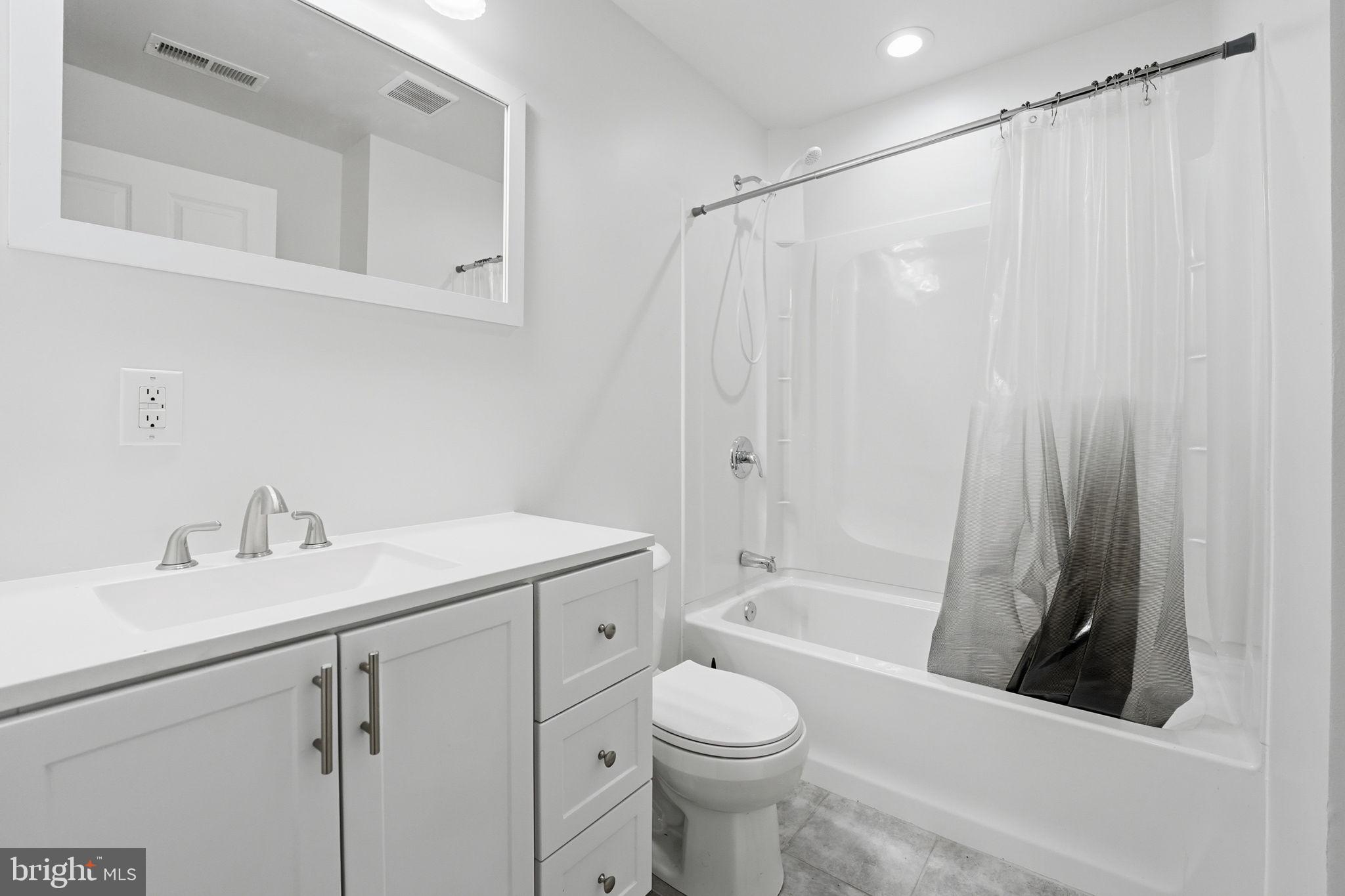 9334 Inaugural Drive King George, VA 22485 - Photo 21 of 26 a bathroom with a sink a toilet and a bathtub