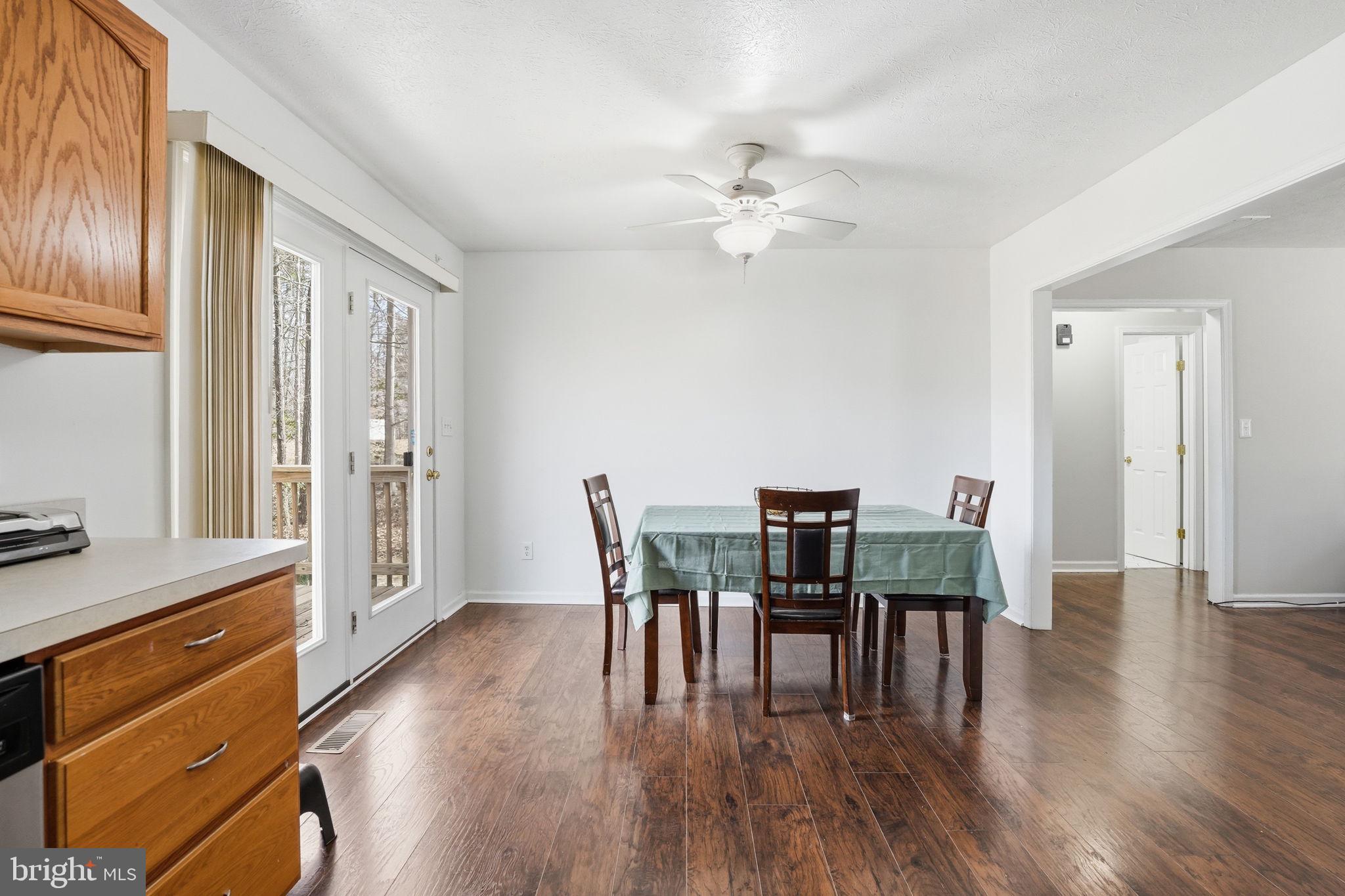 9334 Inaugural Drive King George, VA 22485 - Photo 6 of 26 a view of a dining room with furniture window and wooden floor