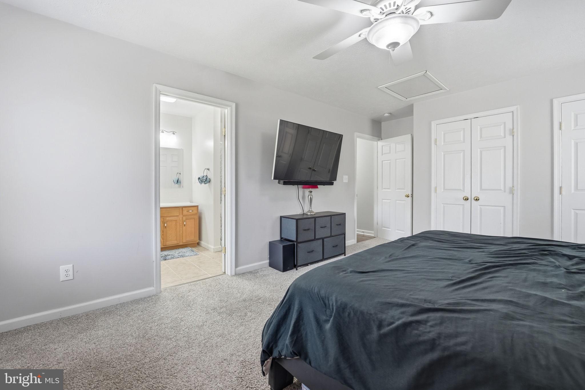 9334 Inaugural Drive King George, VA 22485 - Photo 9 of 26 a bedroom with a bed and a flat screen tv