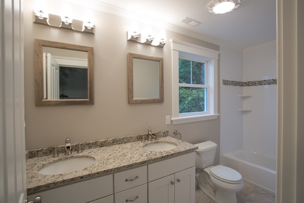 29 Lafayette Road Ipswich, MA 01938 - Photo 13 of 20 a bathroom with a granite countertop sink toilet and mirror