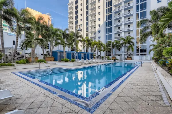 a view of swimming pool with outdoor seating and plants