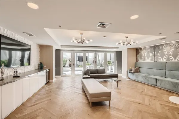a large living room with large couches and kitchen view