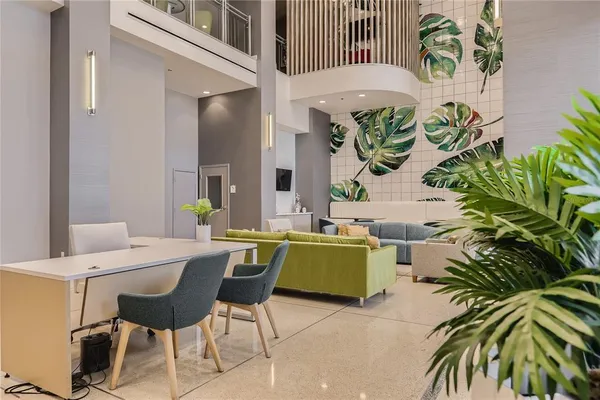 a living room with furniture and a potted plant