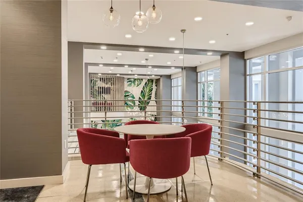 a dining room with furniture a rug and wooden floor