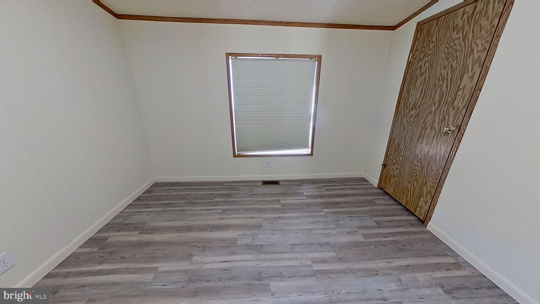 4975 Spring Road Hellam, PA 17406 - Photo 11 of 13 a view of a hallway with wooden floor and staircase