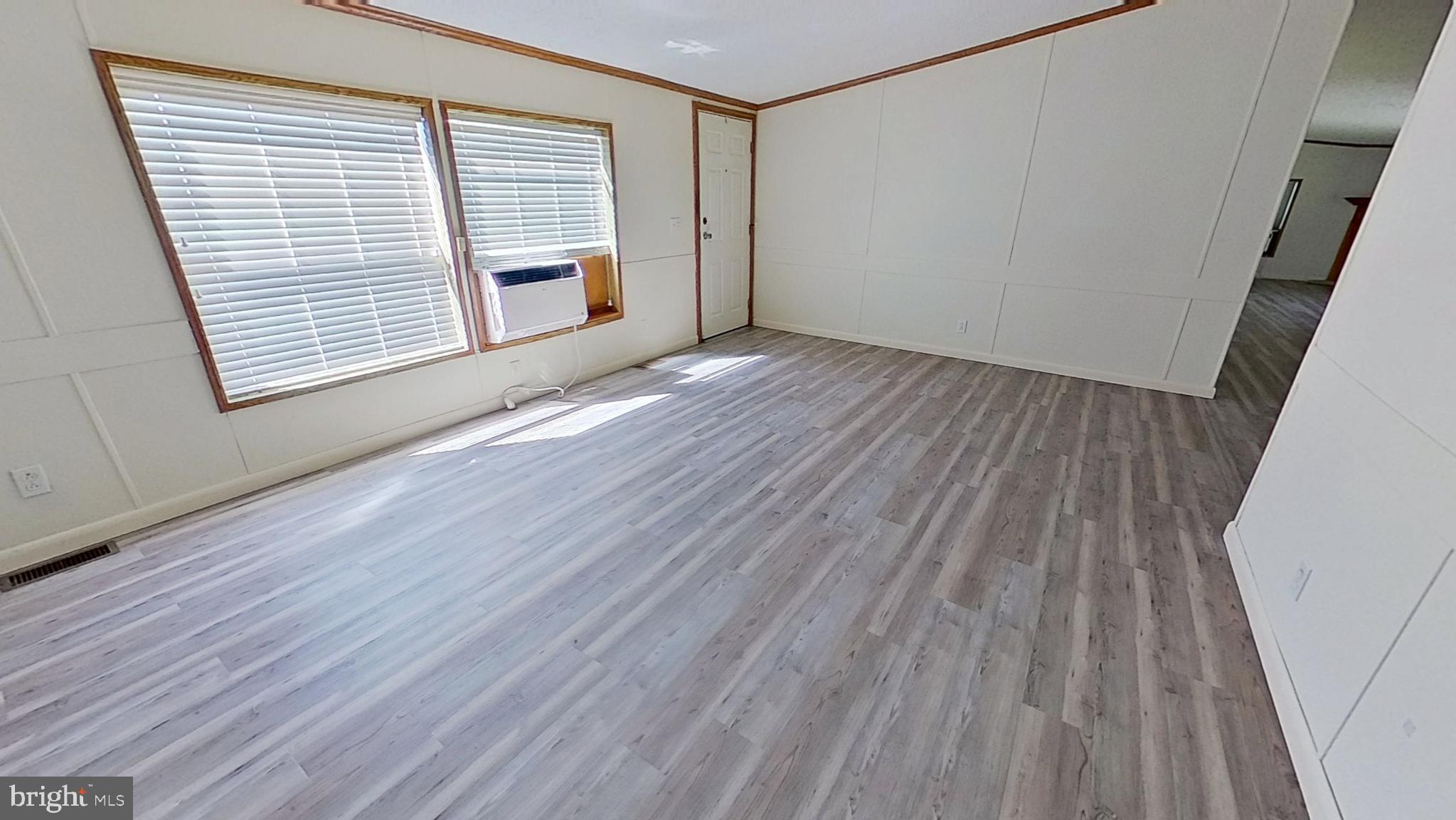 4975 Spring Road Hellam, PA 17406 - Photo 7 of 13 a view of an empty room with wooden floor and a window