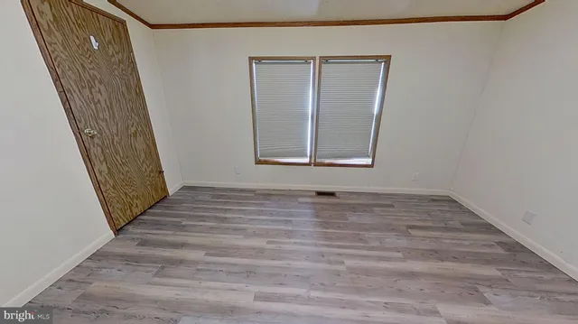 a view of a door with wooden floor and stairs