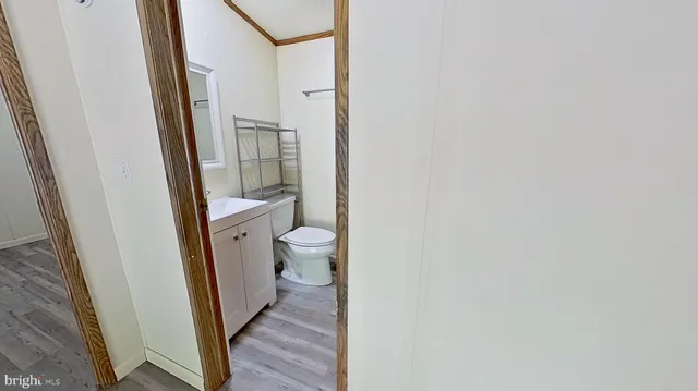 a bathroom with a granite countertop toilet and a sink