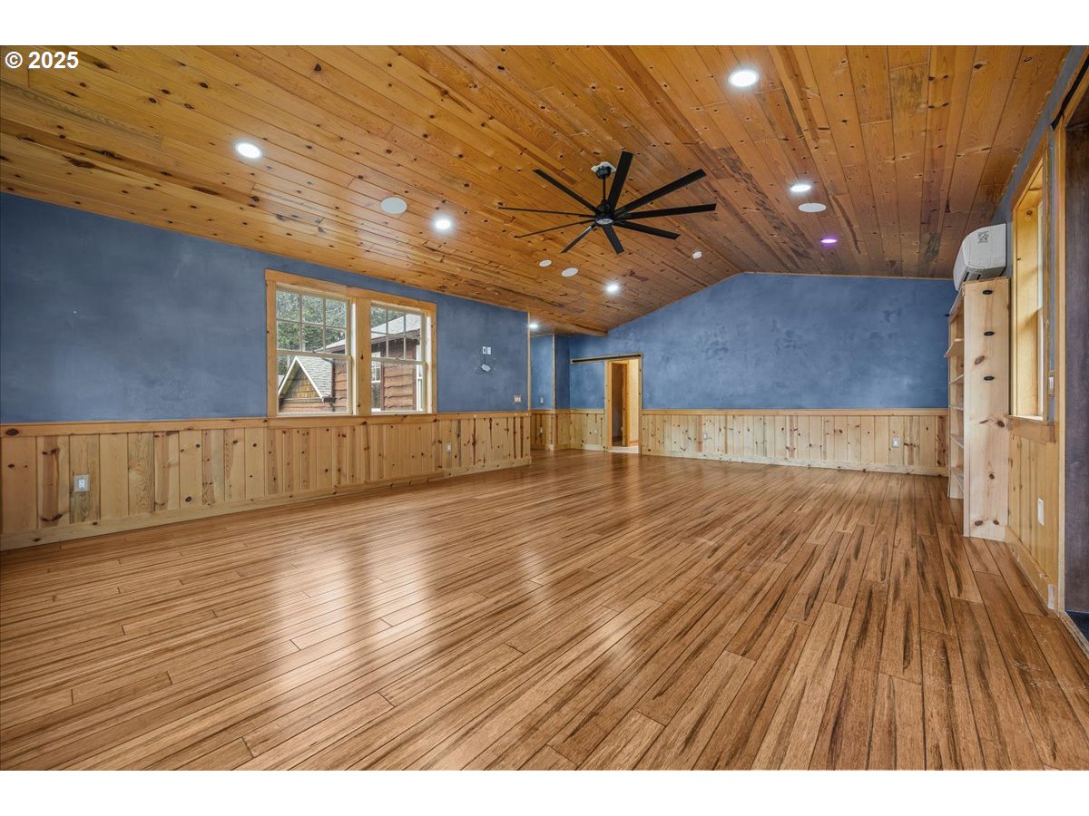 39577 Southeast Kitzmiller Road Eagle Creek, OR 97022 - Photo 18 of 41 a view of an empty room with wooden floor and a ceiling fan