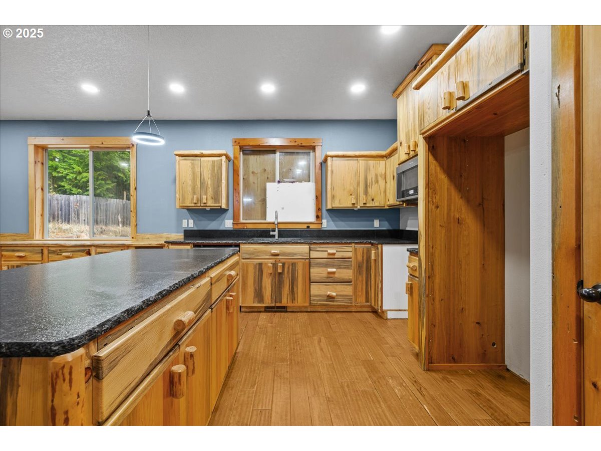 39577 Southeast Kitzmiller Road Eagle Creek, OR 97022 - Photo 4 of 41 a kitchen with granite countertop a sink and a stove